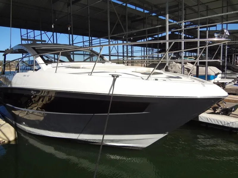 Slide: The Image of 2021 Cruisers Yachts 39 Express Coupe docked under a covered marina. - 18