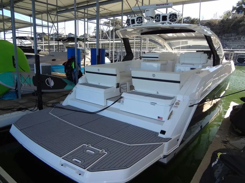 Slide: The Image of 2021 Cruisers Yachts 39 Express Coupe docked, showcasing spacious deck and seating area. - 20