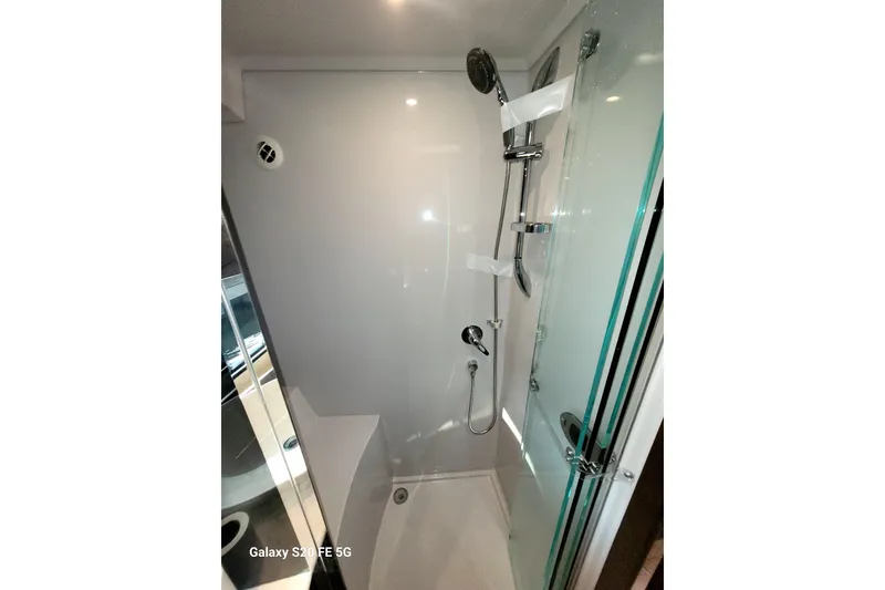 Slide: The Image of Shower area in 2021 Cruisers Yachts 39 Express Coupe, featuring modern fixtures and glass door. - 67
