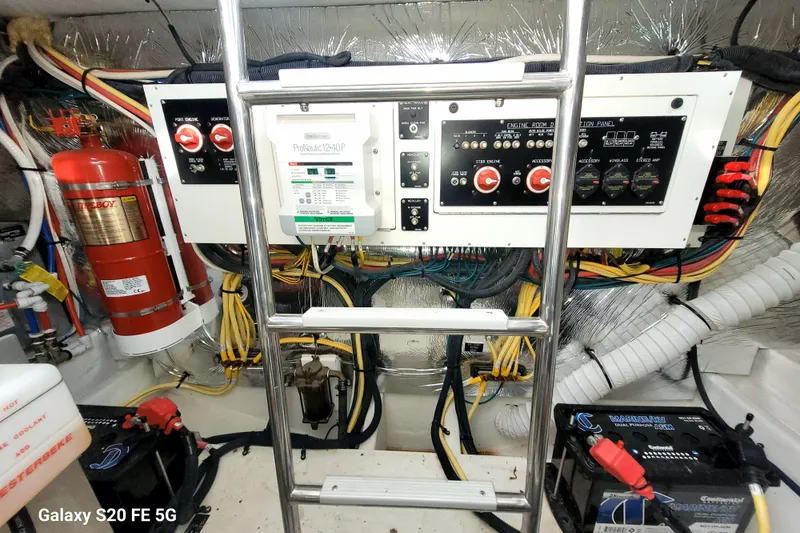 Slide: The Image of Engine room of 2021 Cruisers Yachts 39 Express Coupe with control panels and wiring. - 74