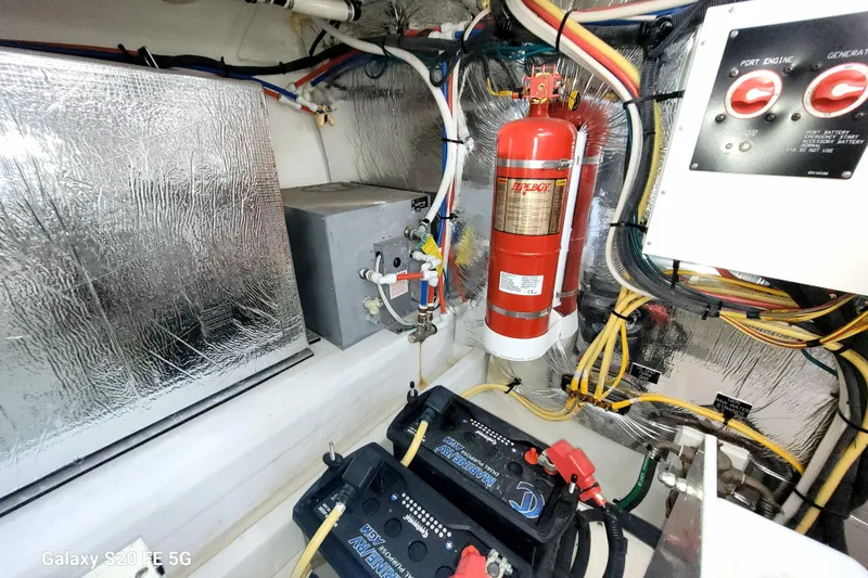Slide: The Image of Engine room of 2021 Cruisers Yachts 39 Express Coupe with fire extinguisher and wiring. - 75