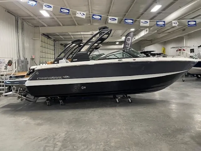 Slide: The Image of 2025 Chaparral 247 SSX boat displayed in a showroom, side view. - 1