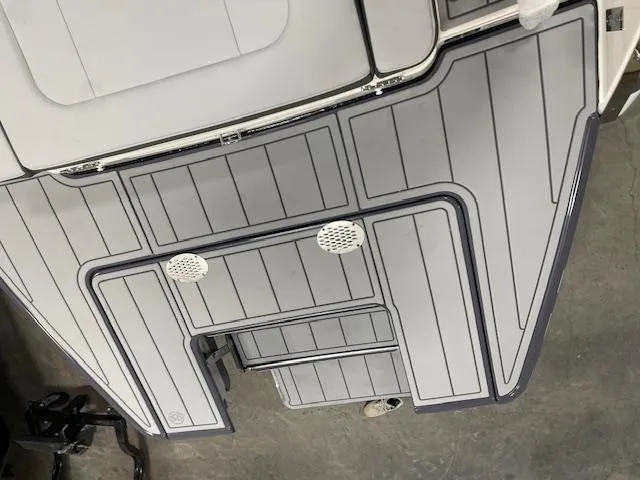 Slide: The Image of 2025 Chaparral 247 SSX boat deck with sleek gray design and detailing. - 11