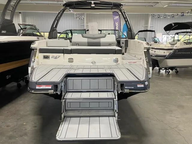 Slide: The Image of 2025 Chaparral 247 SSX boat with sleek design and spacious deck in showroom. - 13