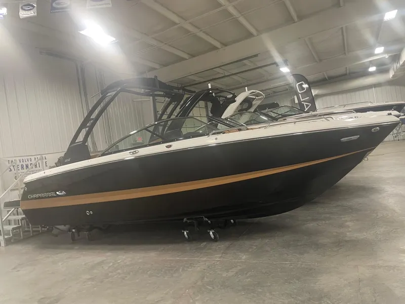 Slide: The Image of 2024 Chaparral 247 SSX boat displayed in an indoor showroom. - 1