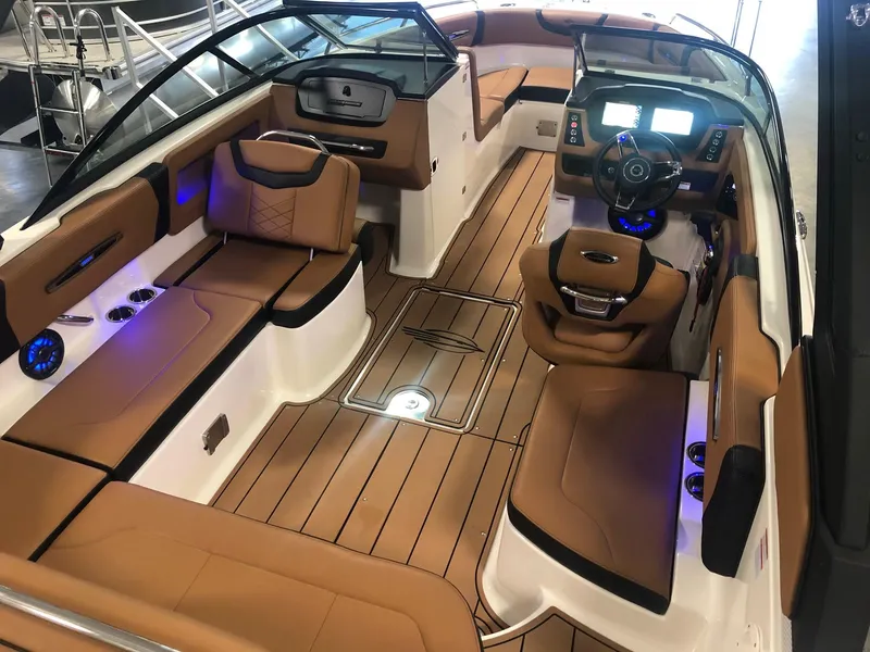 Slide: The Image of 2024 Chaparral 247 SSX boat interior with tan leather seats and modern dashboard. - 5