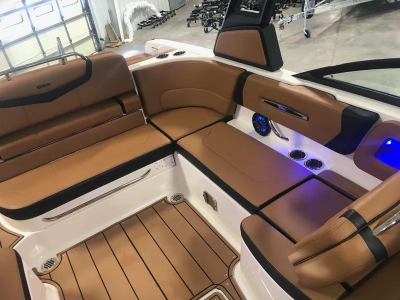 Slide: The Image of 2024 Chaparral 247 SSX boat interior with tan leather seating and modern amenities. - 9