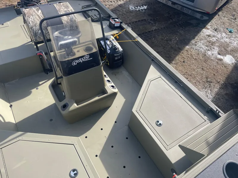 Slide: The Image of 2024 Tracker Grizzly 2072 CC Sportsman boat interior with center console and storage compartments. - 13