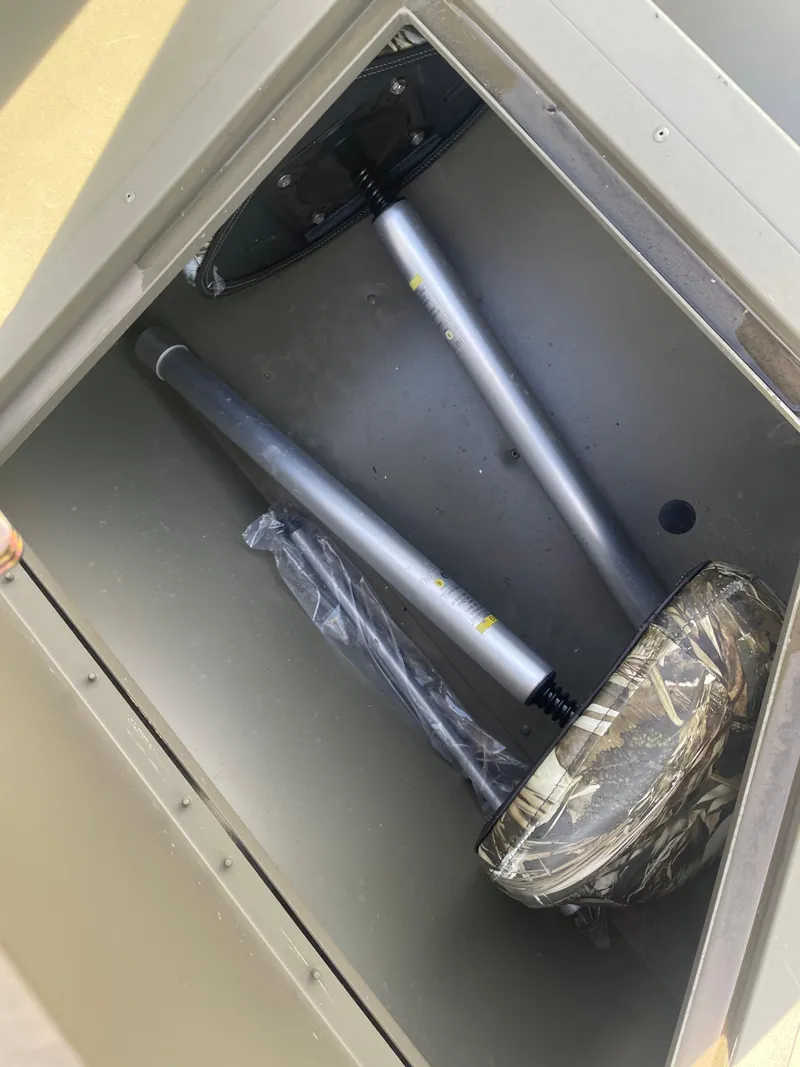 Slide: The Image of Storage compartment of 2024 Tracker Grizzly 2072 CC Sportsman boat with seat pedestals. - 15