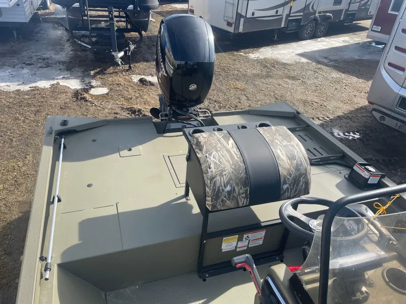 Slide: The Image of 2024 Tracker Grizzly 2072 CC Sportsman boat with camo seats and outboard motor. - 9