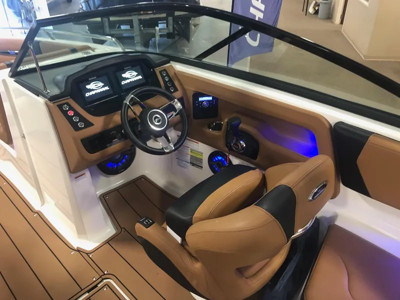 Slide: The Image of 2024 Chaparral 247 SSX boat interior with modern dashboard and leather seating. - 12