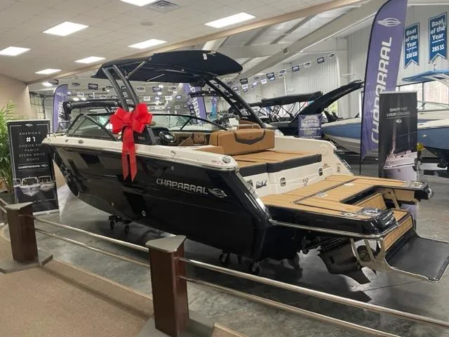 Slide: The Image of 2024 Chaparral 247 SSX boat on display with a red bow in a showroom. - 3