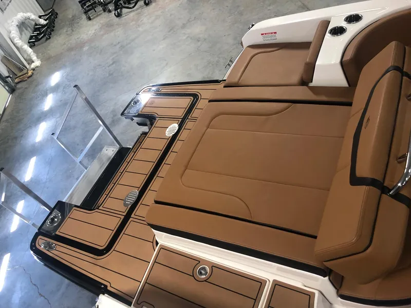 Slide: The Image of 2024 Chaparral 247 SSX boat interior with tan seating and black accents. - 19