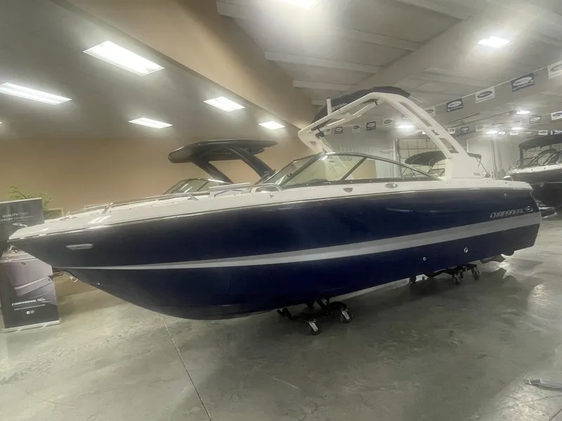 Slide: The Image of 2024 Chaparral 247 SSX boat in showroom, side view. - 1