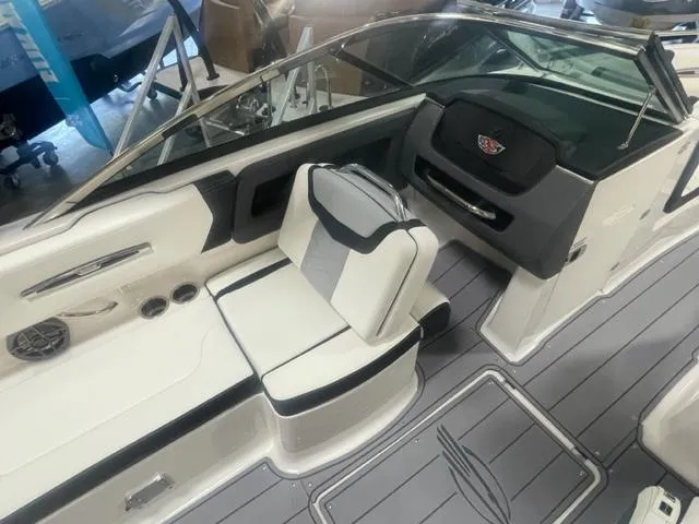 Slide: The Image of 2024 Chaparral 247 SSX boat interior with white and black seating, modern dashboard. - 10