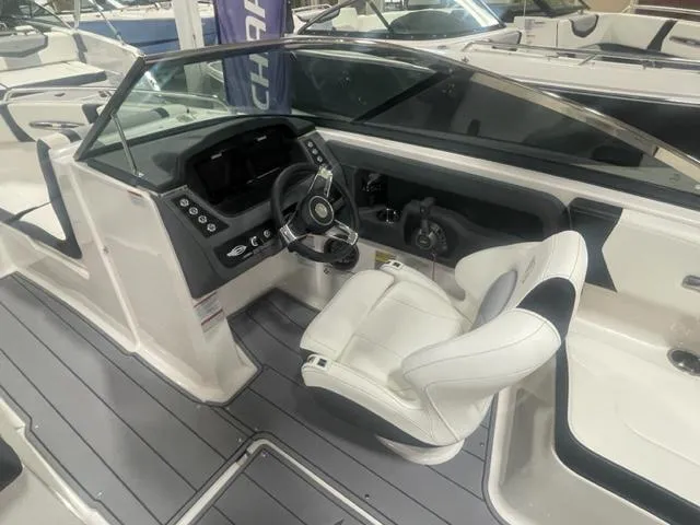 Slide: The Image of 2024 Chaparral 247 SSX boat cockpit with modern helm and white captain's chair. - 12