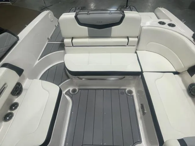 Slide: The Image of 2024 Chaparral 247 SSX boat interior with white and gray seating and flooring. - 13