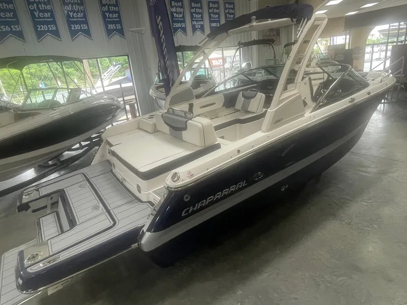 Slide: The Image of 2024 Chaparral 247 SSX boat in showroom, rear view. - 2