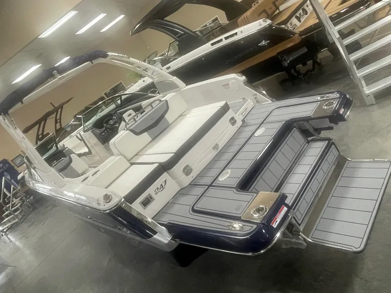 Slide: The Image of 2024 Chaparral 247 SSX boat with spacious seating and swim platform in showroom. - 3