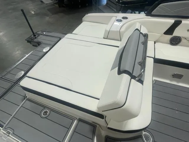Slide: The Image of 2024 Chaparral 247 SSX boat with white and gray seating and deck. - 5