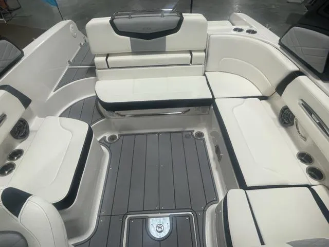 Slide: The Image of 2024 Chaparral 247 SSX boat interior with white and gray seating and flooring. - 7