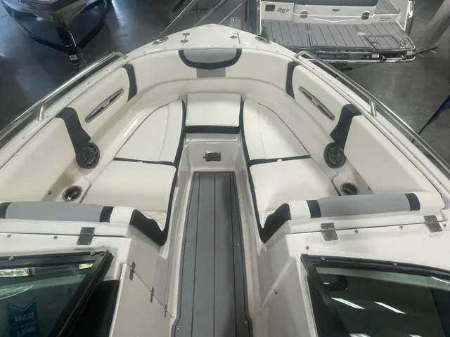 Slide: The Image of 2024 Chaparral 247 SSX boat interior with white and black seating. - 8