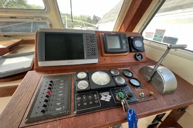 Slide: The Image of 1989 Blue Seas Flybridge Cruiser dashboard with navigation instruments and controls. - 15