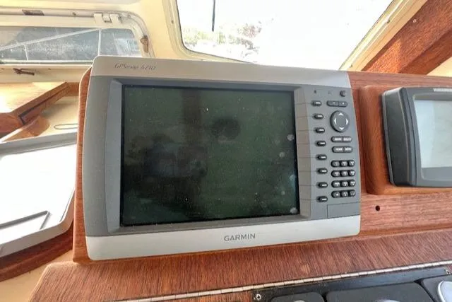 Slide: The Image of Garmin GPS device on 1989 Blue Seas Flybridge Cruiser dashboard. - 18