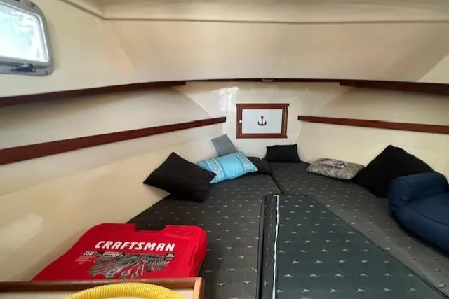 Slide: The Image of Interior cabin of 1989 Blue Seas Flybridge Cruiser with cushions and storage. - 21