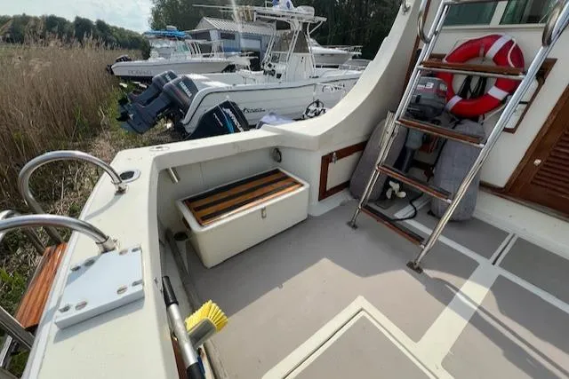 Slide: The Image of 1989 Blue Seas Flybridge Cruiser deck with ladder, storage, and life preserver. - 34