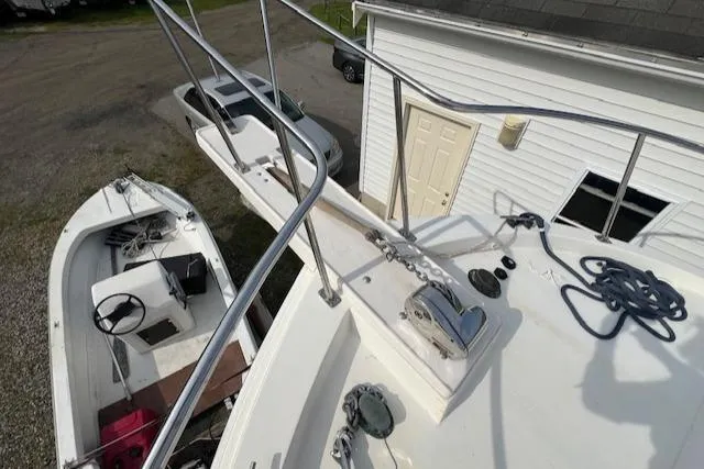 Slide: The Image of 1989 Blue Seas Flybridge Cruiser docked near a white building, view from above. - 36