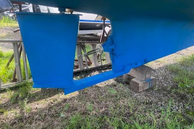 Slide: The Image of 1989 Blue Seas Flybridge Cruiser hull and rudder on dry land. - 41