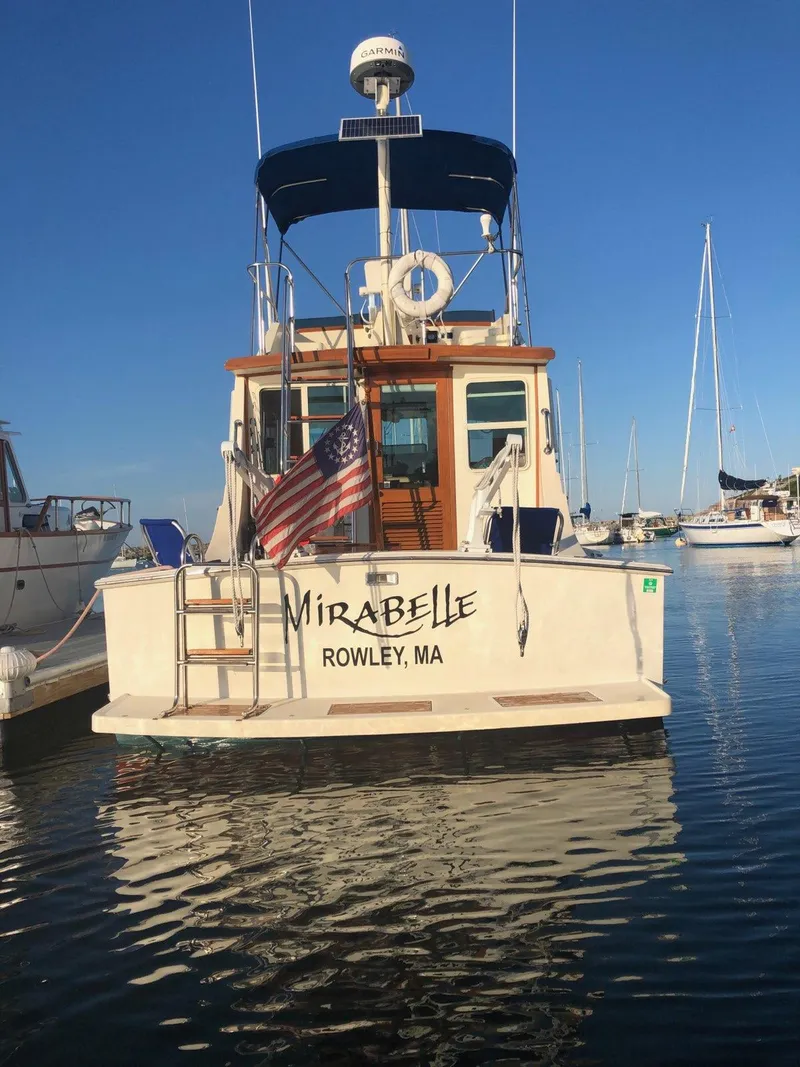 Slide: The Image of 1989 Blue Seas Flybridge Cruiser "Mirabelle" docked in Rowley, MA with American flag. - 48