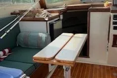 Slide: The Image of Interior of 1989 Blue Seas Flybridge Cruiser with seating and wooden table. - 5