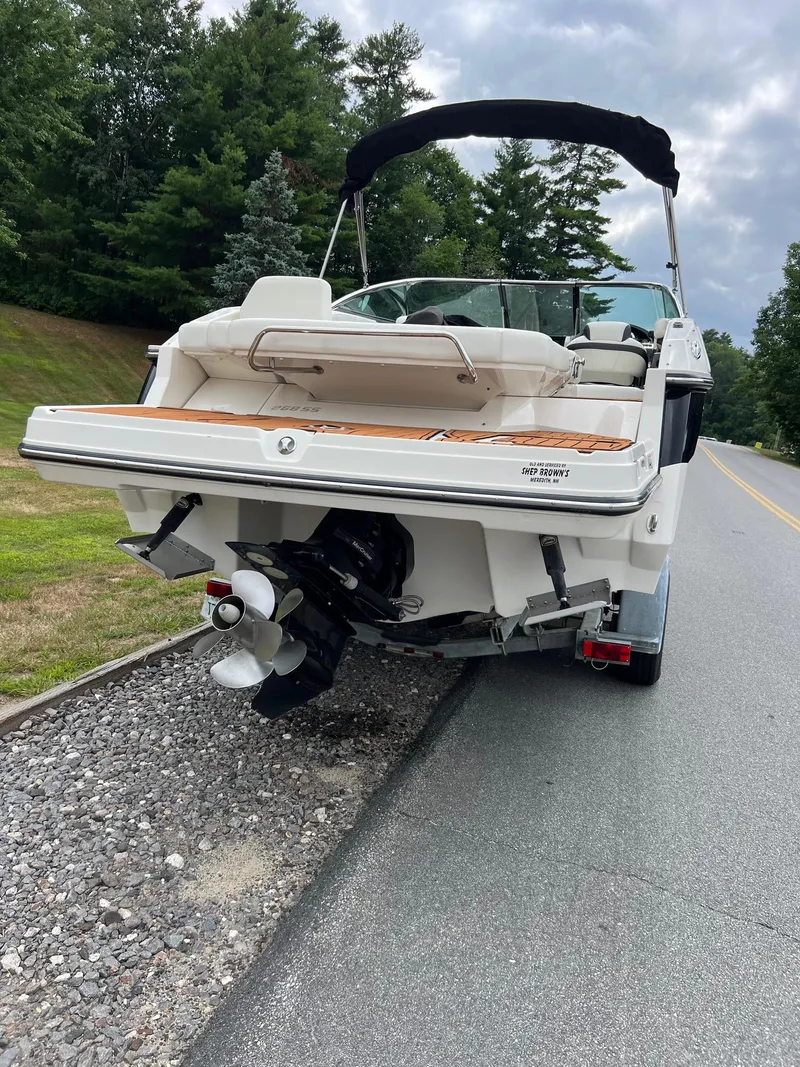 Slide: The Image of 2014 Monterey 268 boat on trailer, parked roadside with lush greenery. - 2