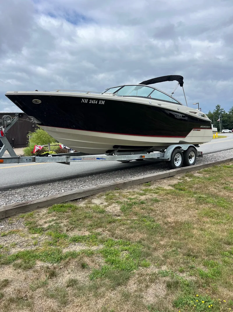 Slide: The Image of 2014 Monterey 268 boat on trailer, parked outdoors under cloudy sky. - 4