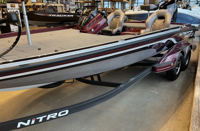 Slide: The Image of 2024 Nitro Z21 XL boat displayed in showroom, featuring sleek design and comfortable seating. - 2