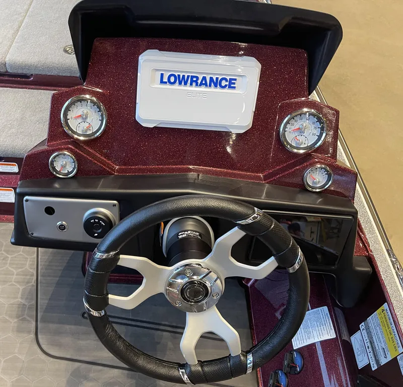 Slide: The Image of 2024 Nitro Z21 XL boat dashboard with Lowrance electronics and steering wheel. - 4