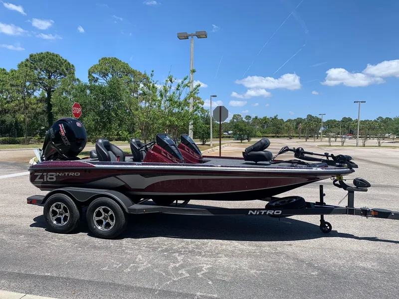 Slide: The Image of 2024 Nitro Z18 bass boat on trailer in parking lot. - 1