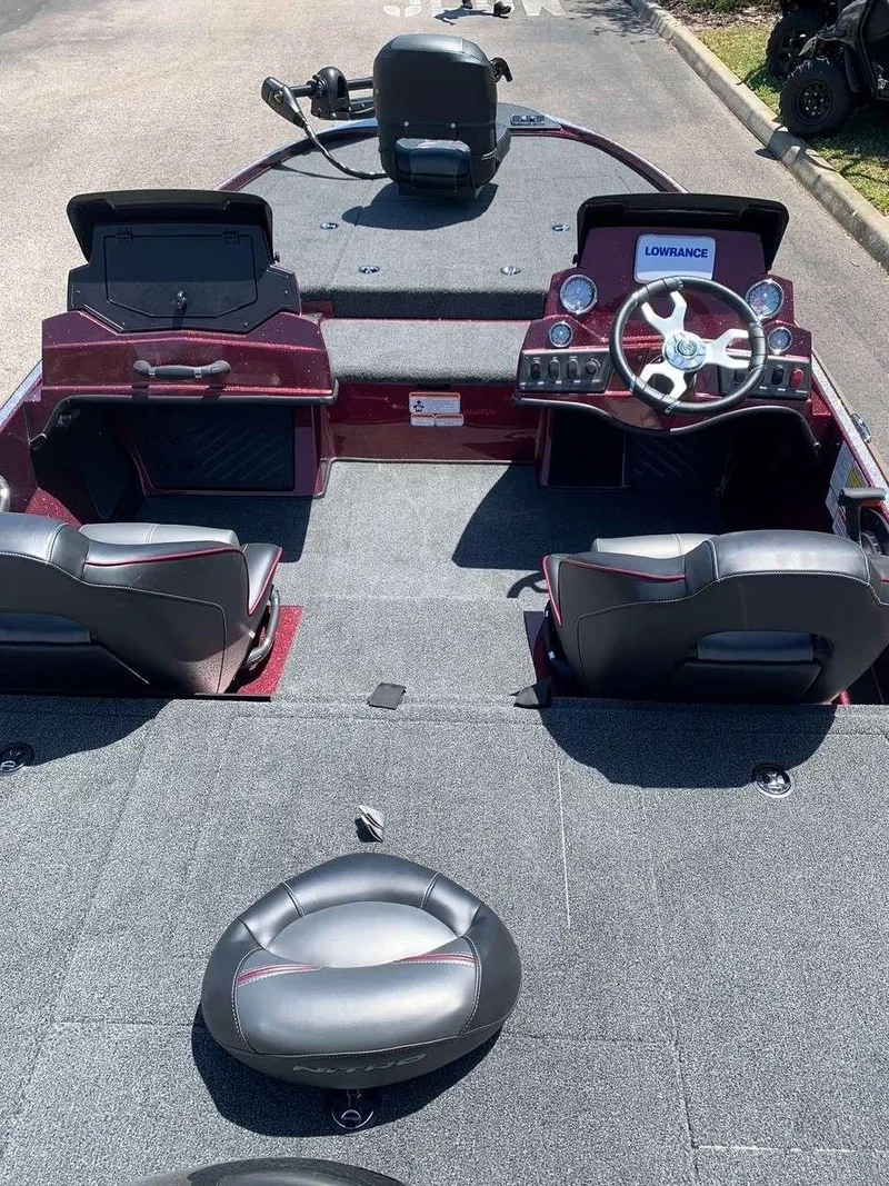Slide: The Image of 2024 Nitro Z18 fishing boat interior with steering console and seating. - 10
