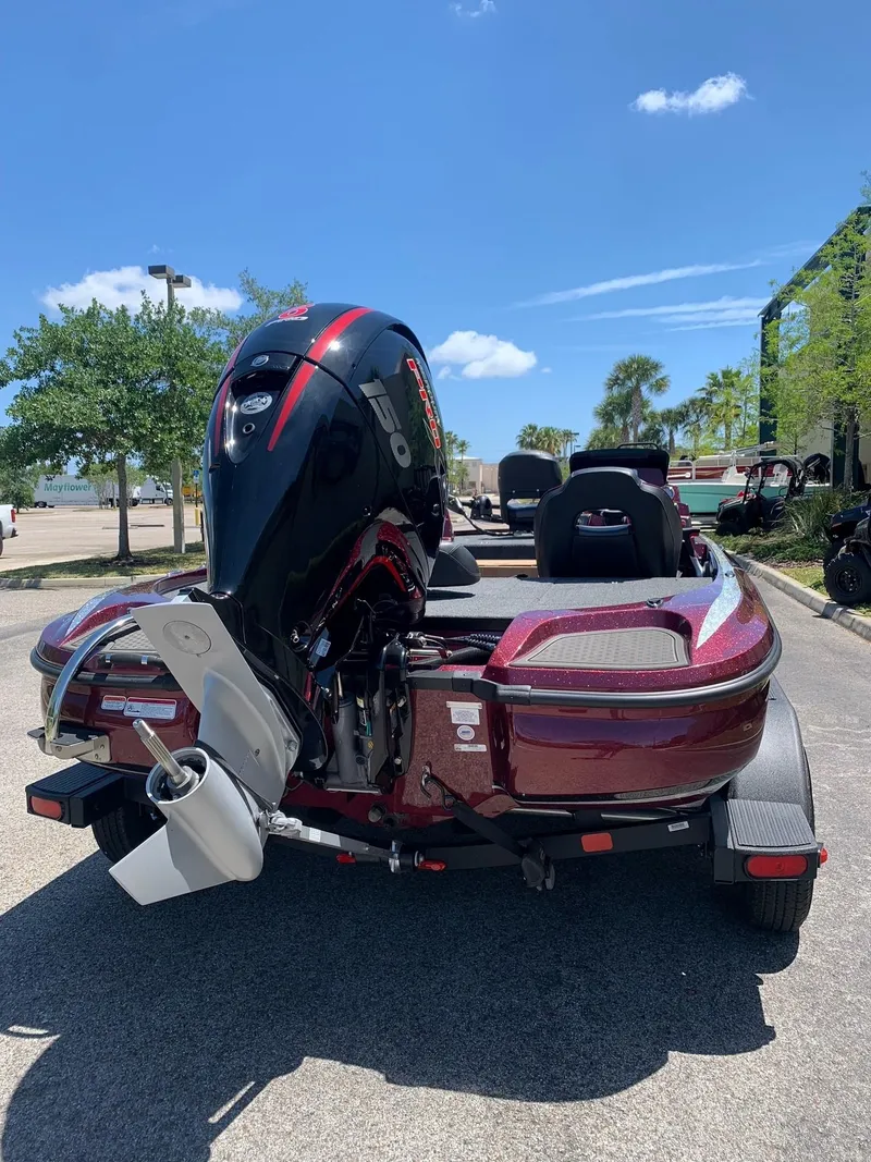 Slide: The Image of 2024 Nitro Z18 boat with powerful outboard motor, parked on a sunny day. - 2