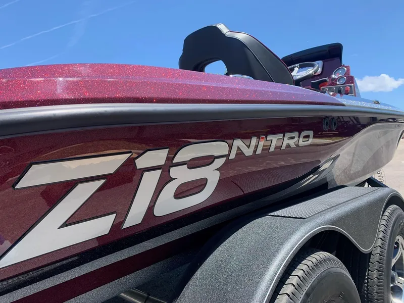 Slide: The Image of 2024 Nitro Z18 boat in maroon color on a trailer under a clear blue sky. - 3