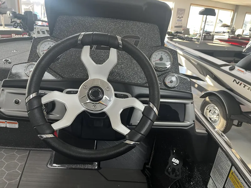 Slide: The Image of Steering wheel of a 2024 Nitro Z20 boat in a showroom setting. - 7