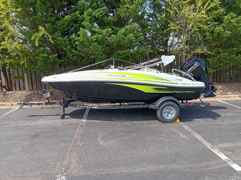 Slide: The Image of 2024 Tahoe T16 boat on trailer in parking lot, surrounded by trees. - 3