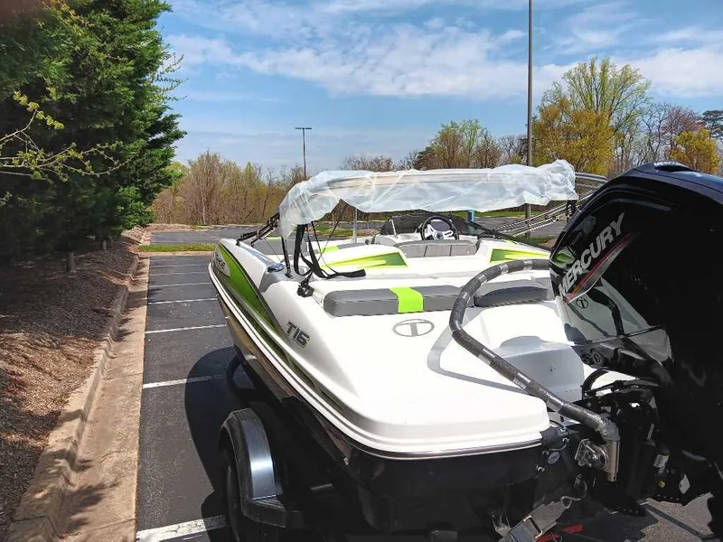 Slide: The Image of 2024 Tahoe T16 boat with Mercury engine in a parking lot. - 7