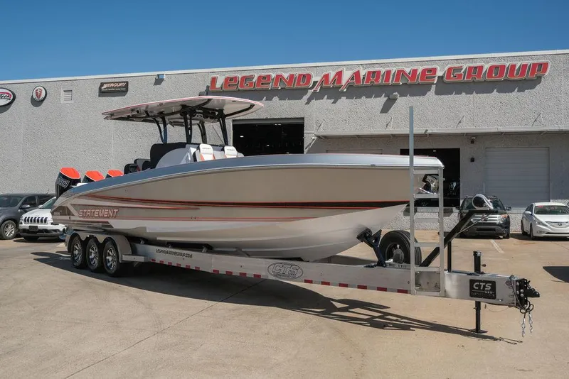 Slide: The Image of 2025 Statement 350 Open boat on trailer at Legend Marine Group dealership. - 1