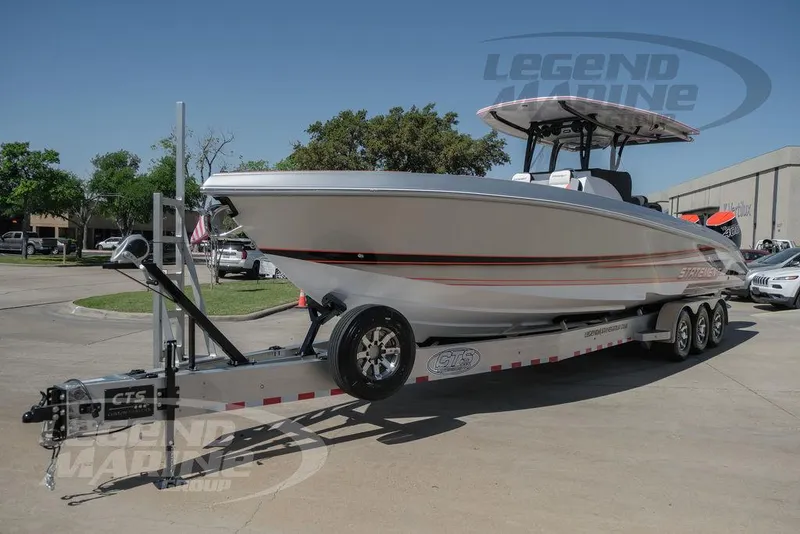 Slide: The Image of 2025 Statement 350 Open boat on a trailer in a parking lot. - 2