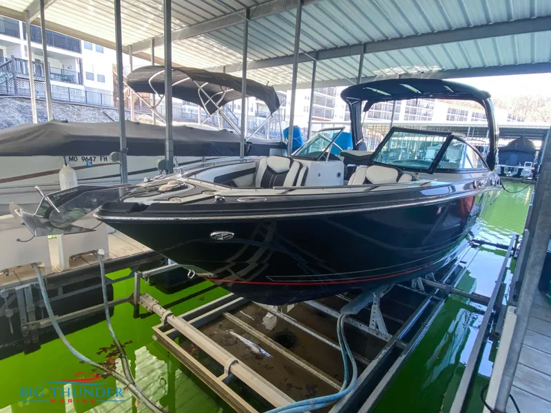 Slide: The Image of 2021 Monterey 278SS boat docked in a marina under a covered slip. - 11