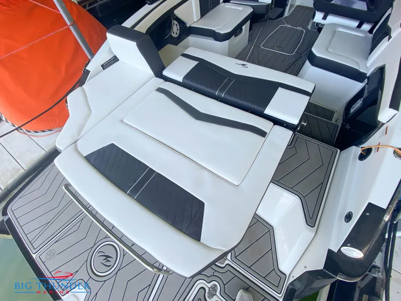 Slide: The Image of 2021 Monterey 278SS boat interior with black and white seating and deck. - 17