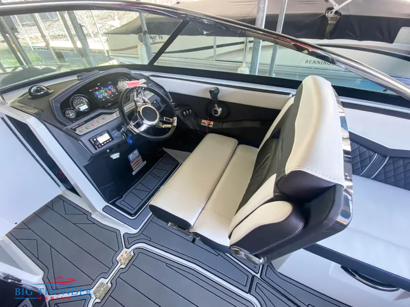 Slide: The Image of 2021 Monterey 278SS boat cockpit with steering wheel and captain's seat. - 28